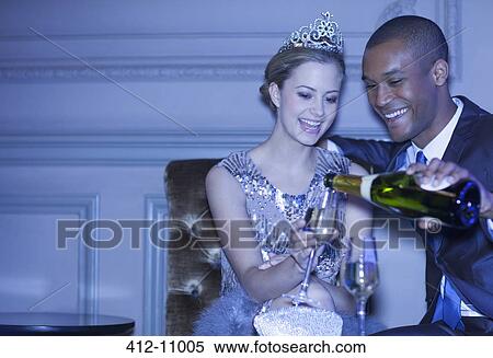 Man pouring champagne for woman in tiara View Large Photo Image Stock Photography - Man pouring champagne for woman in tiara. Fotosearch