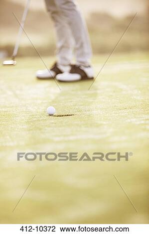 Man putting on golf course View Large Photo Image Stock Image - Man putting on golf course. Fotosearch