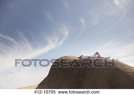 Man relaxing on rock formation View Large Photo Image Stock Photography - Man relaxing on rock formation. Fotosearch