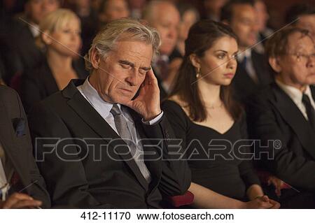 Man sleeping in theater audience View Large Photo Image Stock Image - Man sleeping in theater audience. Fotosearch