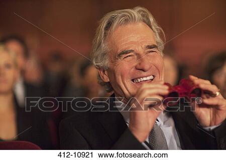 Man with opera glasses laughing in theater audience View Large Photo Image Stock Image - Man with opera glasses laughing in theater audience. Fotosearch