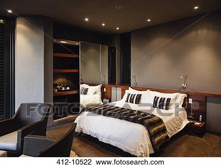 Mirror and bed in modern bedroom View Large Photo Image Stock Image - Mirror and bed in modern bedroom. Fotosearch