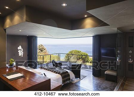 Stock Photo - Modern bedroom overlooking ocean. Fotosearch