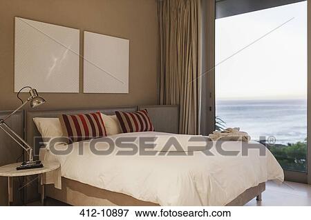 Modern bedroom with ocean view View Large Photo Image Stock Photo - Modern bedroom with ocean view. Fotosearch