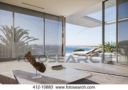 Modern living room and patio overlooking ocean View Large Photo Image Stock Image - Modern living room and patio overlooking ocean. Fotosearch