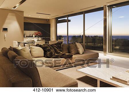 Modern living room overlooking ocean at sunset View Large Photo Image Stock Image - Modern living room overlooking ocean at sunset. Fotosearch