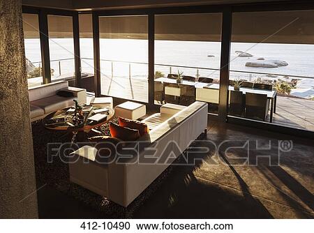 Stock Image - Modern living room overlooking ocean. Fotosearch