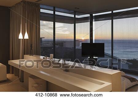 Modern sink in bedroom overlooking ocean at sunset View Large Photo Image Stock Photo - Modern sink in bedroom overlooking ocean at sunset. Fotosearch