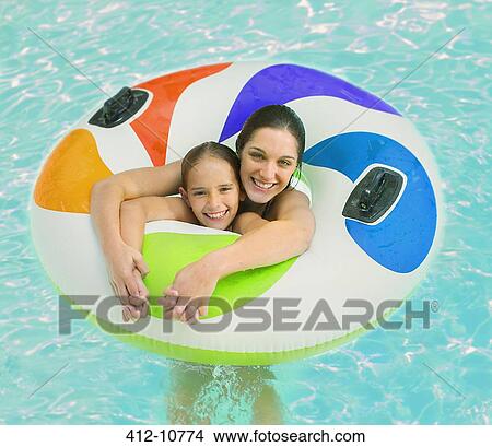 Mother and daughter playing in swimming pool View Large Photo Image Picture - Mother and daughter playing in swimming pool. Fotosearch