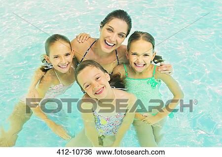 Mother and daughters swimming in pool View Large Photo Image Stock Photograph - Mother and daughters swimming in pool. Fotosearch