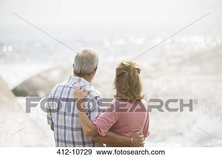 Older couple hugging on beach View Large Photo Image Stock Photo - Older couple hugging on beach. Fotosearch