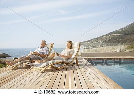 Older couple relaxing by pool View Large Photo Image Stock Image - Older couple relaxing by pool. Fotosearch