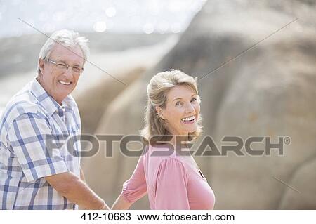 Older couple walking outdoors View Large Photo Image Stock Image - Older couple walking outdoors. Fotosearch