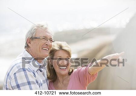 Stock Image - Older couple walking outdoors. Fotosearch