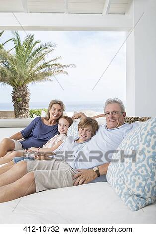 Older couple with grandchildren on sofa View Large Photo Image Stock Image - Older couple with grandchildren on sofa. Fotosearch