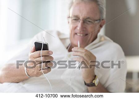 Older man using cell phone View Large Photo Image Stock Image - Older man using cell phone. Fotosearch
