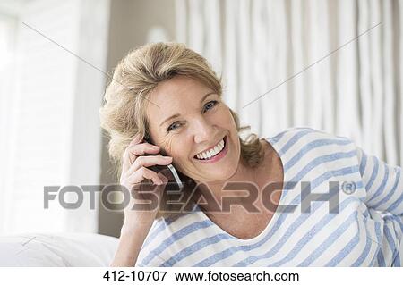 Older woman talking on cell phone View Large Photo Image Stock Photo - Older woman talking on cell phone. Fotosearch