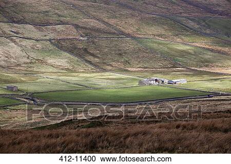 Stock Image - Pastures and farm in rural landscape. Fotosearch