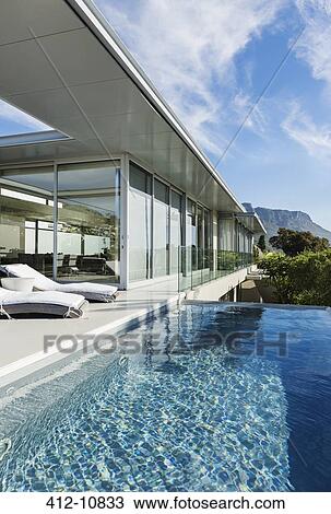 Patio and pool along modern house View Large Photo Image Stock Image - Patio and pool along modern house. Fotosearch