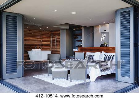 Patio doors open to modern bedroom View Large Photo Image Picture - Patio doors open to modern bedroom. Fotosearch