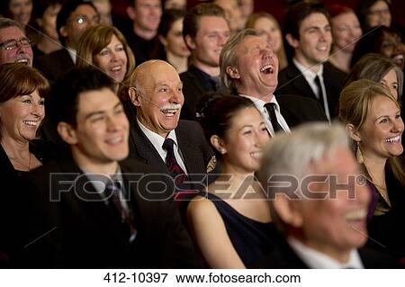 People smiling and laughing in theater audience View Large Photo Image Stock Photo - People smiling and laughing in theater audience. Fotosearch