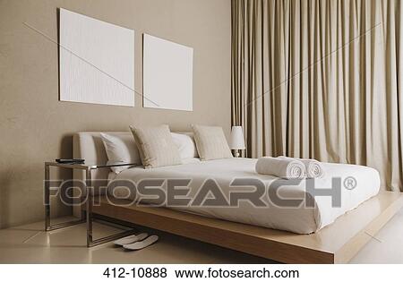 Stock Photo - Platform bed in modern bedroom. Fotosearch