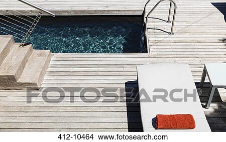 Picture - Pool and wooden deck of modern house. Fotosearch