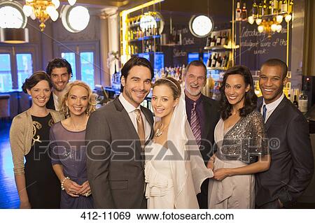 Stock Photo - Portrait of bride and groom with family. Fotosearch