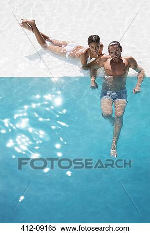 Portrait of smiling couple relaxing in swimming pool View Large Photo Image Stock Photography - Portrait of smiling couple relaxing in swimming pool. Fotosearch