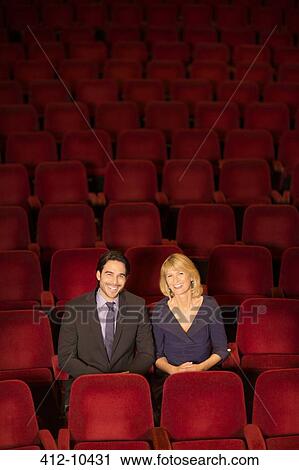Portrait of smiling couple sitting in empty theater View Large Photo Image Stock Image - Portrait of smiling couple sitting in empty theater. Fotosearch