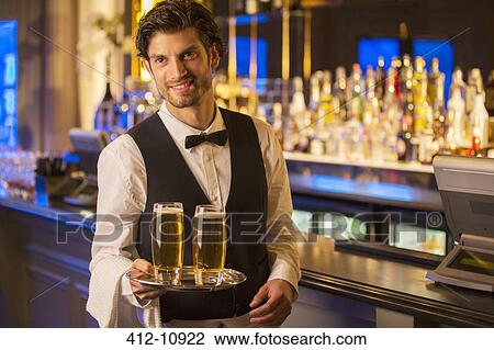 Portrait of well dressed bartender carrying beers on tray View Large Photo Image Stock Image - Portrait of well dressed bartender carrying beers on tray. Fotosearch