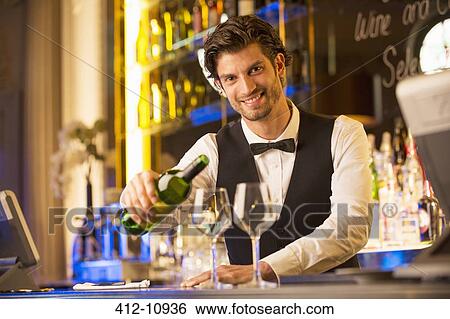 Portrait of well dressed bartender pouring wine in luxury bar View Large Photo Image Stock Photograph - Portrait of well dressed bartender pouring wine in luxury bar. Fotosearch