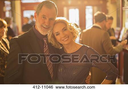 Portrait of well dressed couple in theater lobby View Large Photo Image Stock Photograph - Portrait of well dressed couple in theater lobby. Fotosearch