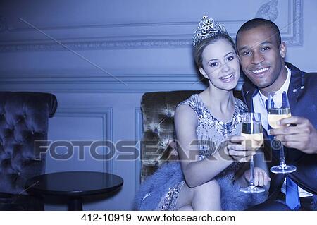 Portrait of well dressed couple toasting champagne flutes View Large Photo Image Stock Photo - Portrait of well dressed couple toasting champagne flutes. Fotosearch