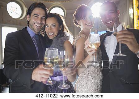 Portrait of well dressed couples toasting champagne and wine glasses View Large Photo Image Stock Image - Portrait of well dressed couples toasting champagne and wine glasses. Fotosearch