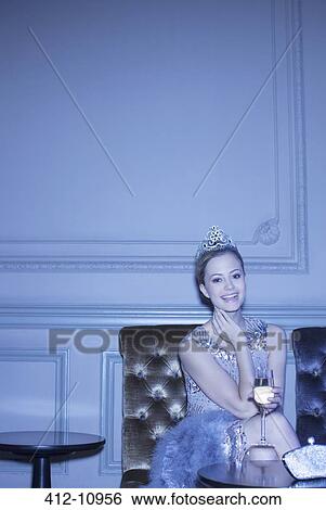 Portrait of well dressed woman wearing tiara and drinking champagne View Large Photo Image Stock Photograph - Portrait of well dressed woman wearing tiara and drinking champagne. Fotosearch