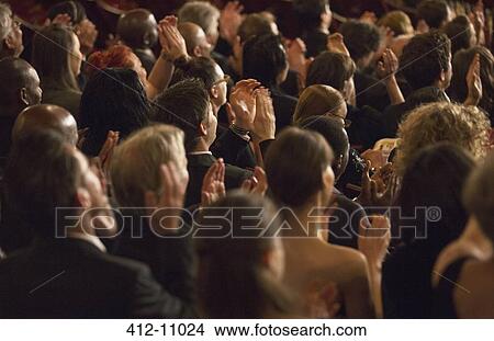 Picture - Rear view of clapping theater audience. Fotosearch