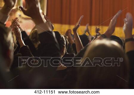 Rear view of clapping theater audience View Large Photo Image Stock Image - Rear view of clapping theater audience. Fotosearch