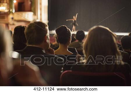 Rear view of theater audience watching performers on stage View Large Photo Image Picture - Rear view of theater audience watching performers on stage. Fotosearch