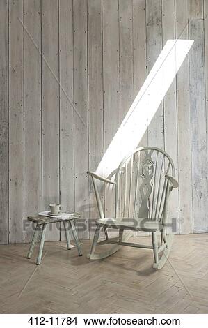Picture - Rocking chair and side table. Fotosearch