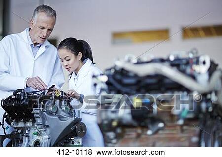Scientists working on machine View Large Photo Image Stock Photo - Scientists working on machine. Fotosearch