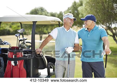 Senior men laughing next to golf cart View Large Photo Image Stock Photo - Senior men laughing next to golf cart. Fotosearch