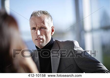 Serious businessman in meeting View Large Photo Image Stock Photo - Serious businessman in meeting. Fotosearch