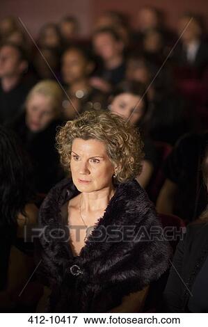 Serious woman in theater audience View Large Photo Image Stock Photo - Serious woman in theater audience. Fotosearch