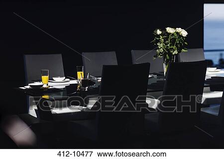 Stock Photo - Set table in modern dining room. Fotosearch