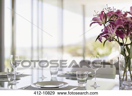 Stock Photo - Set table in modern dining room. Fotosearch
