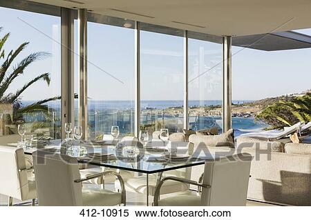 Set table in modern dining room overlooking ocean View Large Photo Image Stock Photography - Set table in modern dining room overlooking ocean. Fotosearch