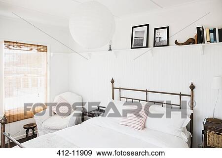 Shelf above bed in white bedroom View Large Photo Image Stock Photo - Shelf above bed in white bedroom. Fotosearch