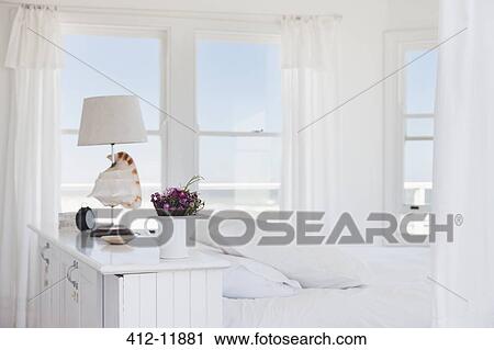 Shell lamp in bedroom overlooking ocean View Large Photo Image Stock Image - Shell lamp in bedroom overlooking ocean. Fotosearch