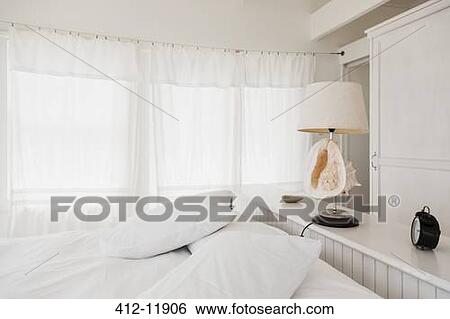 Shell lamp in white bedroom View Large Photo Image Stock Photograph - Shell lamp in white bedroom. Fotosearch